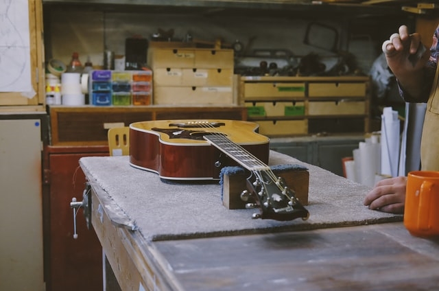 Photo of acoustic guitar on workbench