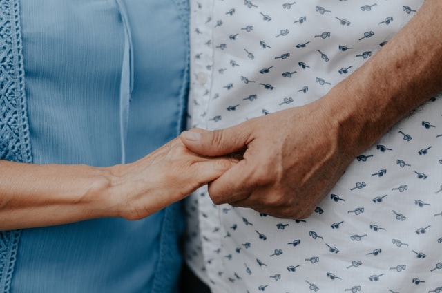 Close up photo of two hands clasped together