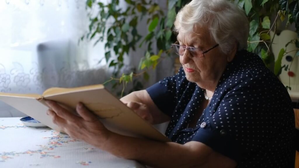 Care Home resident reading a book