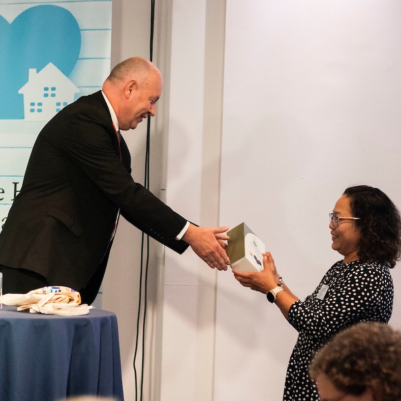Rodelie (Del) Austria receiving her winning prize for the scavenger hunt anagram