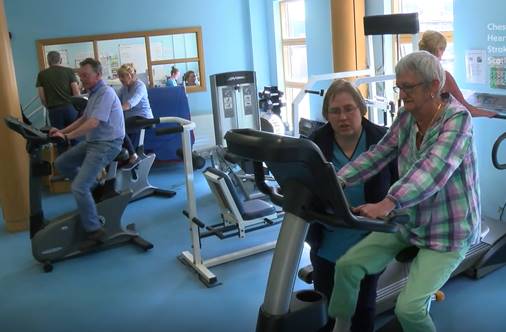 Several patients on exercise bikes.