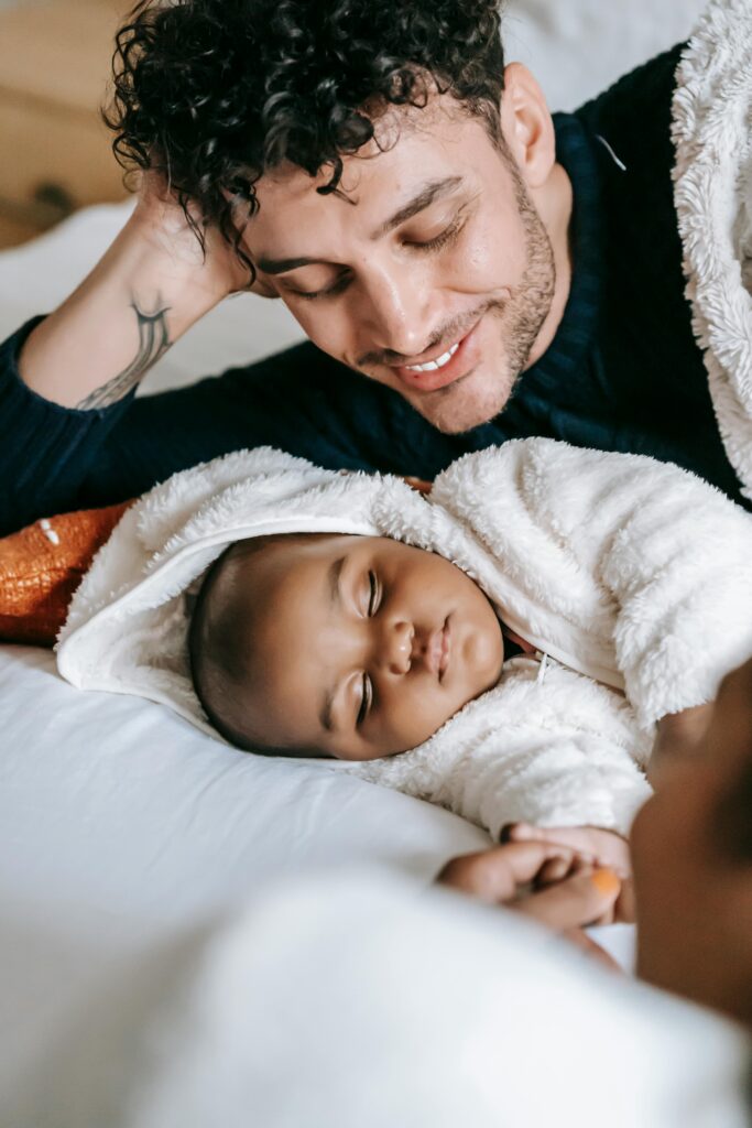 Photo by William Fortunato : https://www.pexels.com/photo/loving-ethnic-father-and-black-sleepy-infant-6392960/