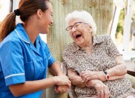 Nurse and patient laughing.