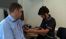 bp nurse sitting with patient