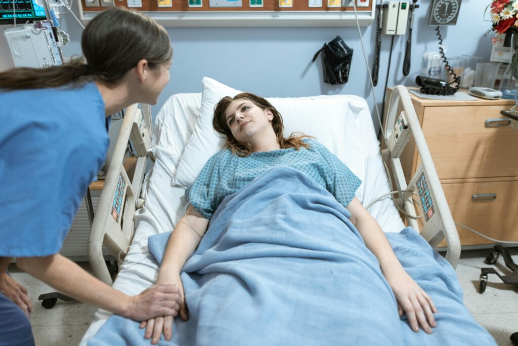 Women in bed looking at nurse