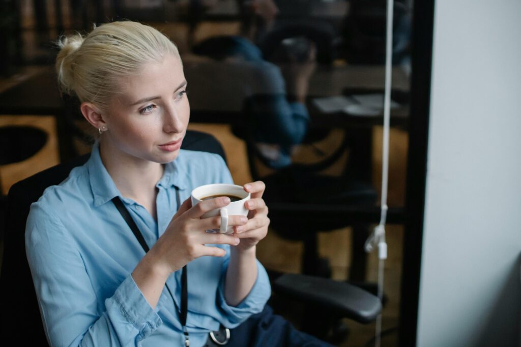 Woman drinking a coffee looking out of a window