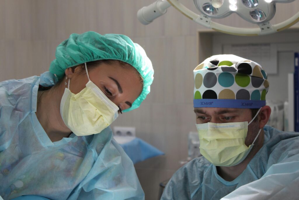 Two clinicians doing surgery