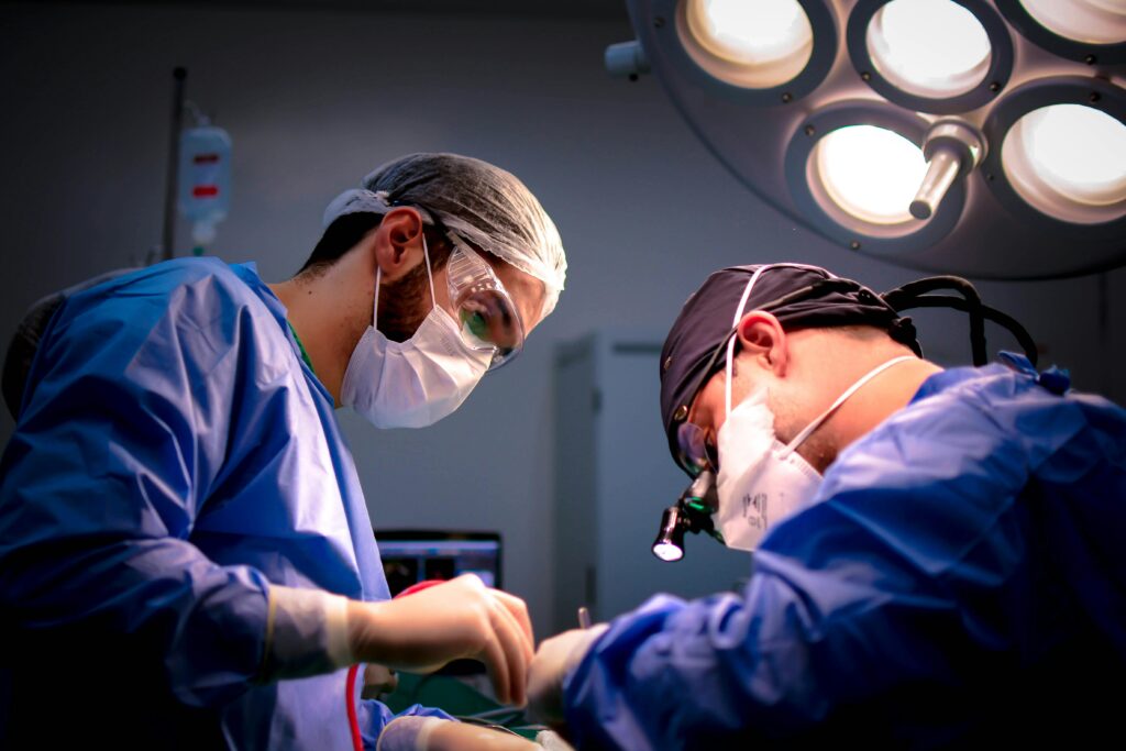 Two clinicians doing surgery
