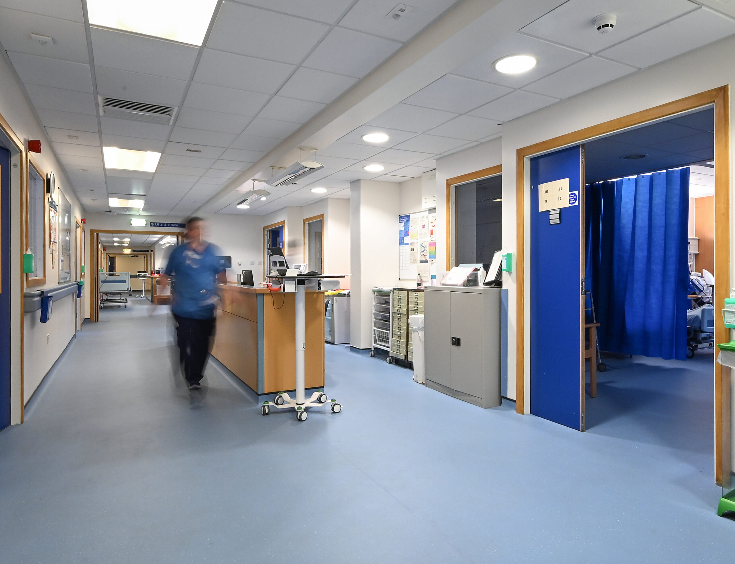 Ward 210 - Woman walking down the corridor