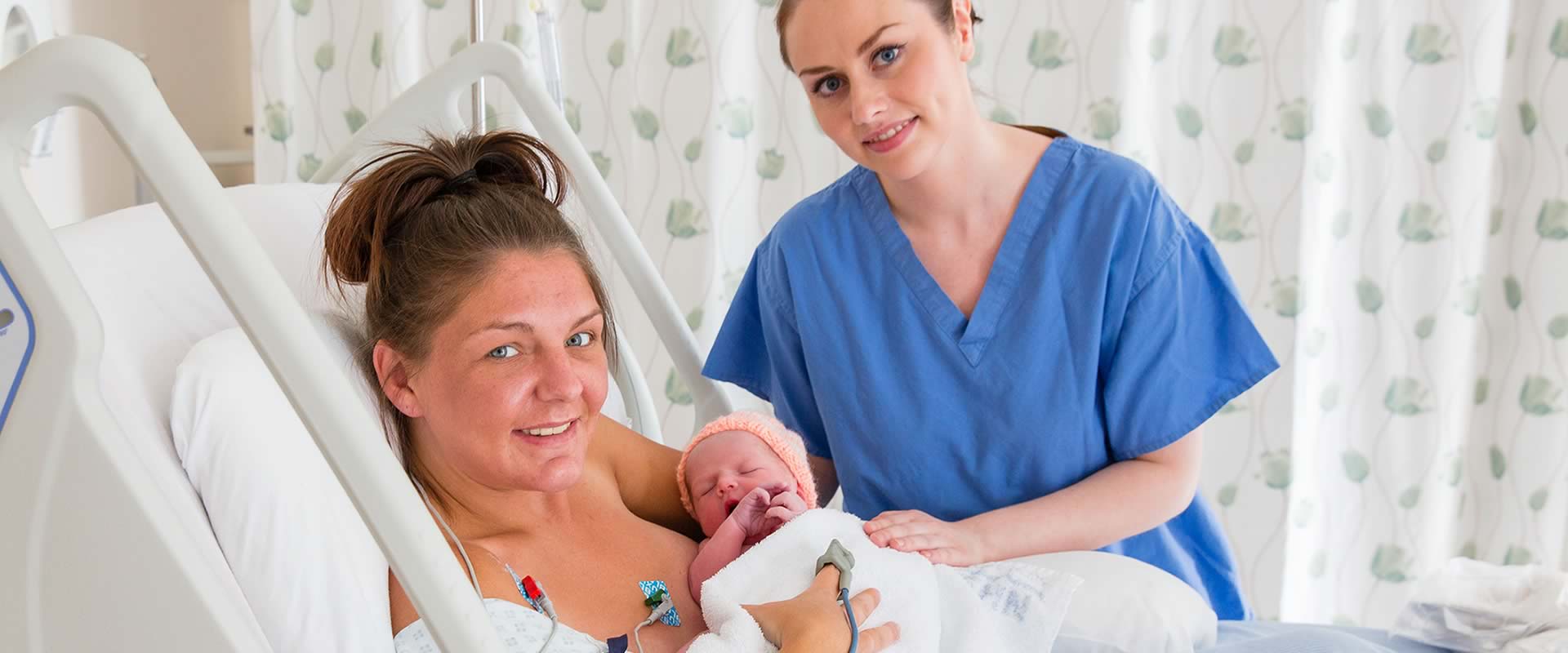 A woman and her newborn baby in a hospital post delivery suite
