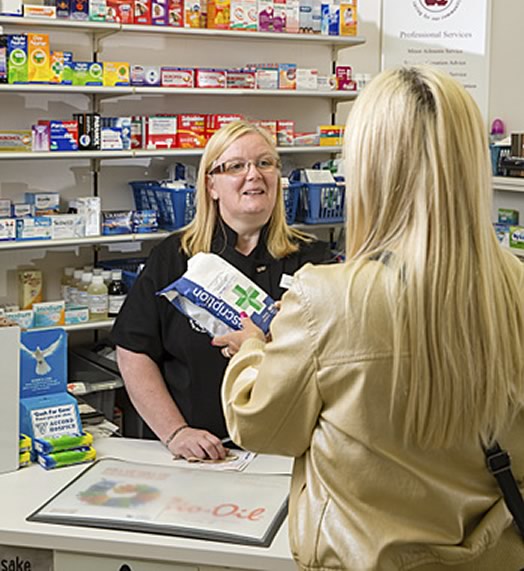 Pharmacist and patient inside a pharmacy
