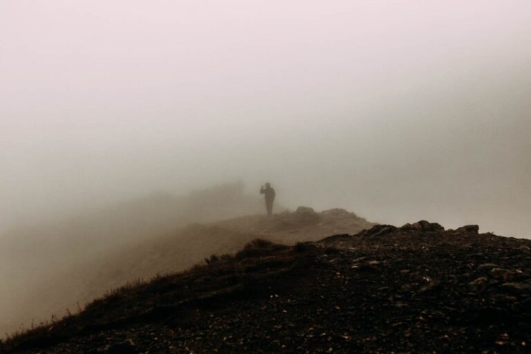 A misty moor with a vague outline of a hill-walker