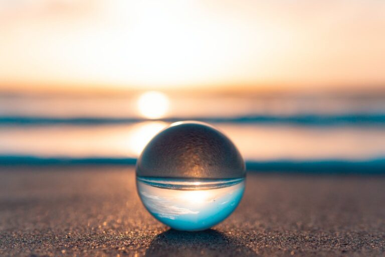 A glass marble on a beach